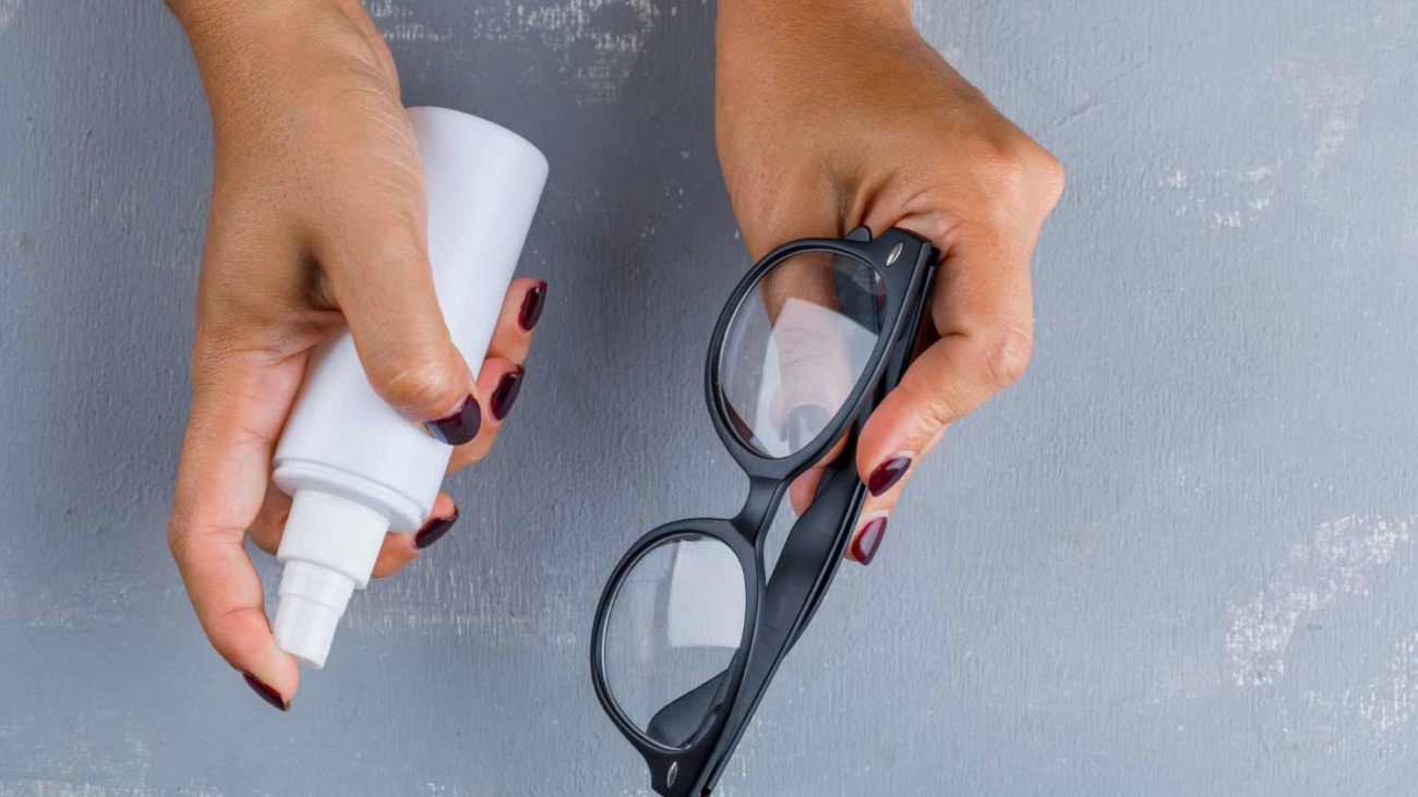 virus-prevention-concept-flat-lay-woman-cleaning-glasses